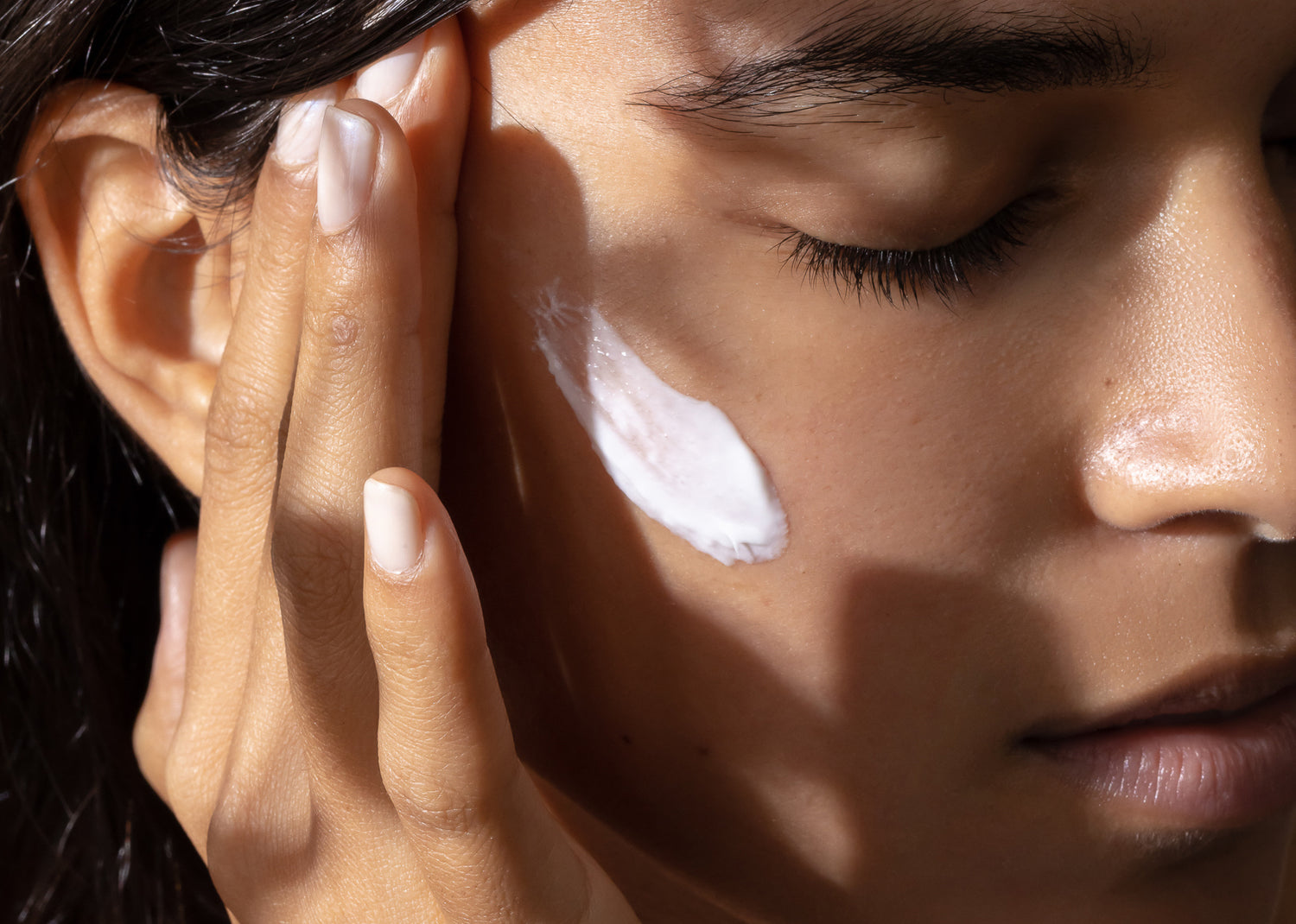 rosafa model applying timeless reset face cream