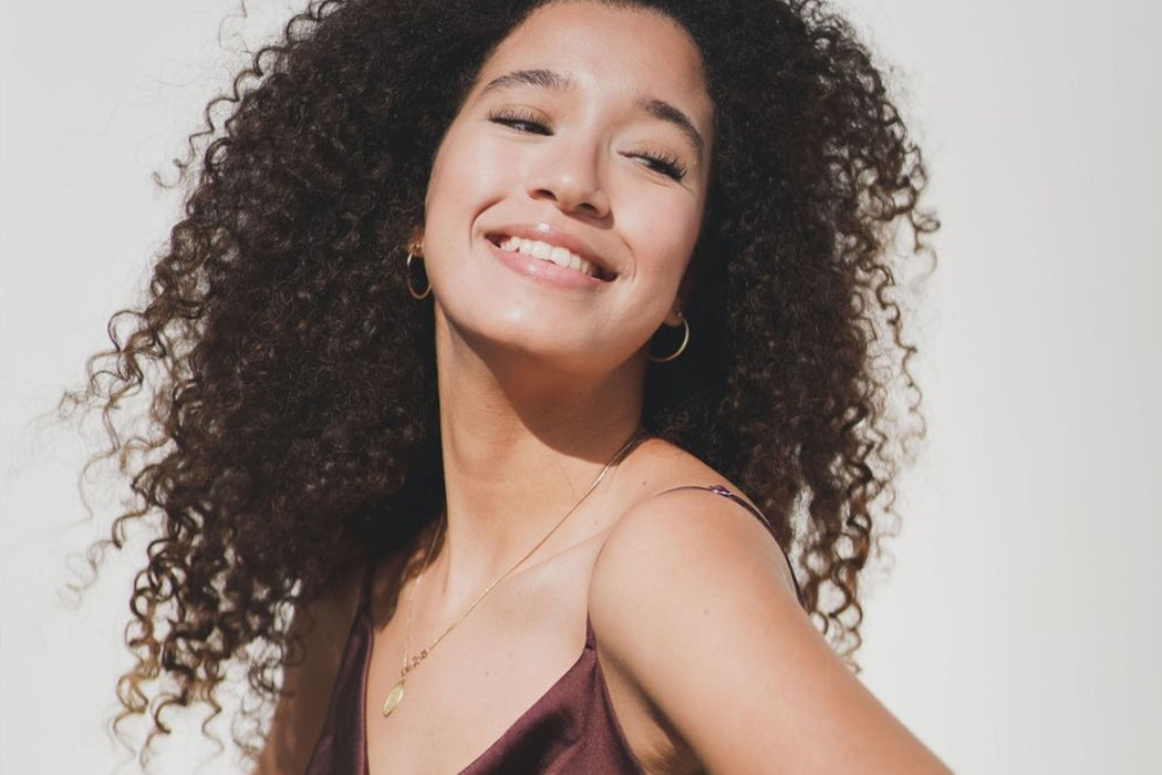 rosafa model with curly hair smiling
